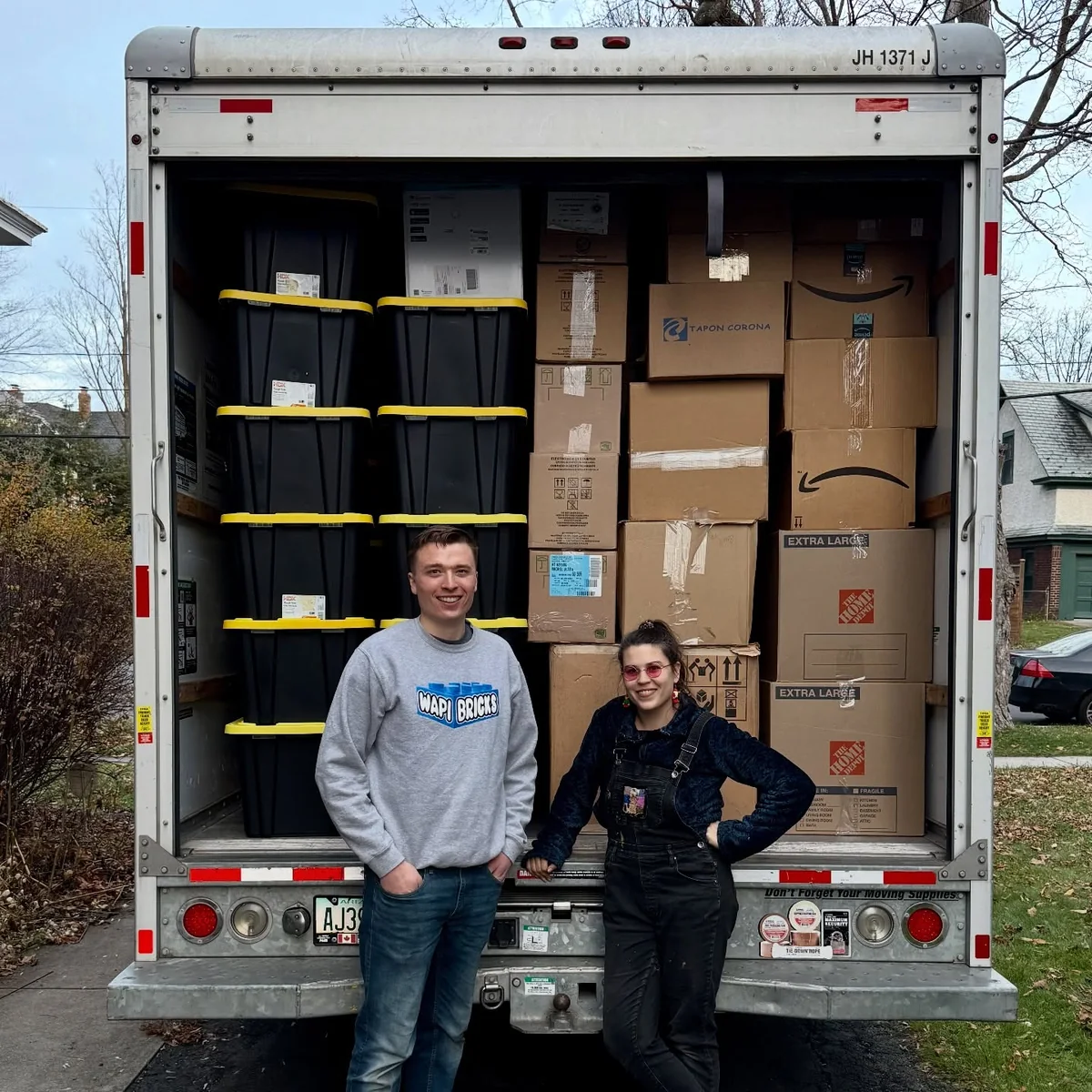 Zach and Adrienne beside the loaded truck carrying her father’s LEGO collection